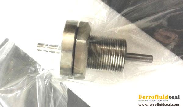 Magnetic fluid shaft rotary motion feedthrough